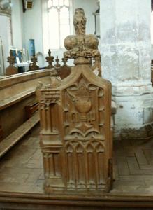 Bench end carving with initials of Alicia de la Pole.