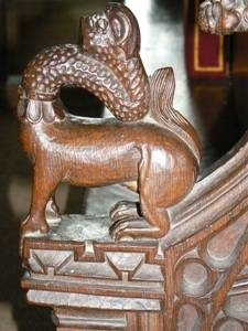 Arm rest carving. Possibly a giraffe.