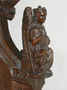 Carving of angel on the arm rest