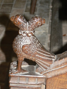 Carving of two headed eagle on arm rest