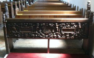 Close-up of carving on back of rear bench.