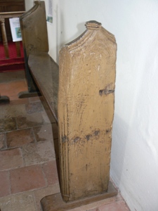 A very old bench behind the linenfold one. Somewhat battered!