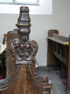 Carving at the top of a bench end.