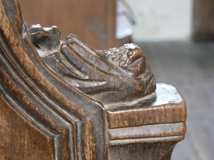 Carved figure on the arm rest.