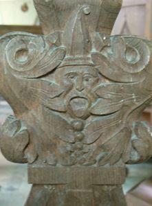 Green Man carving on the end of a choir stall.