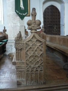 Intricately carved bench end.