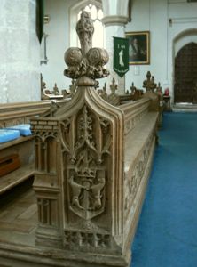 Bench end carving with arms of the Talbot family.